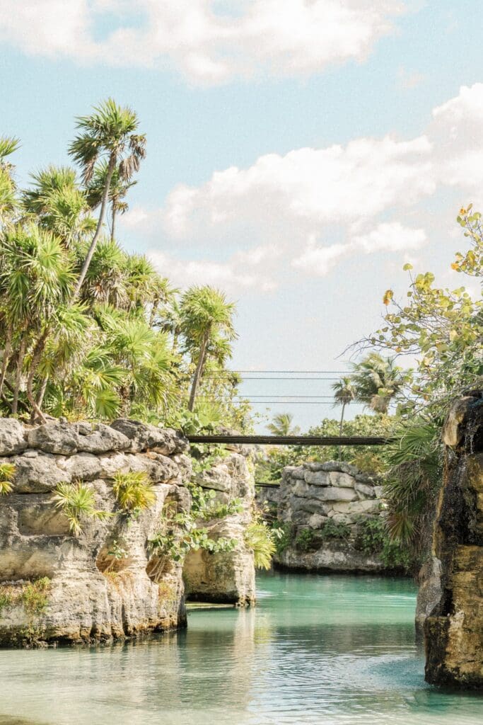 Turquoise waterways and tropical cliffs at Hotel Xcaret Mexico near Playa del Carmen, a stunning Riviera Maya destination wedding resort.