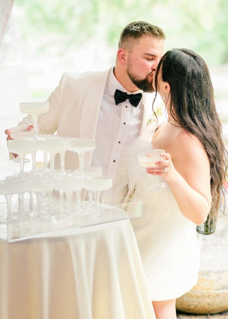 Courtney and Hunter pour a champagne tower during their wedding reception at The Dempsey Event Center in Delaware, Ohio.